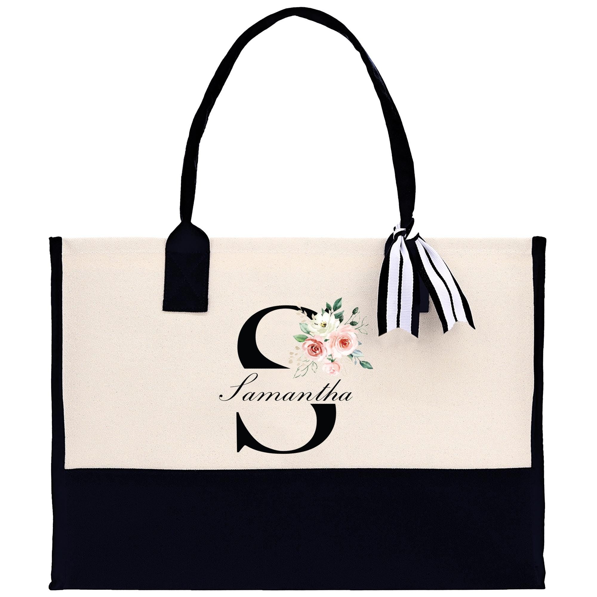 a black and white bag with a flower on it