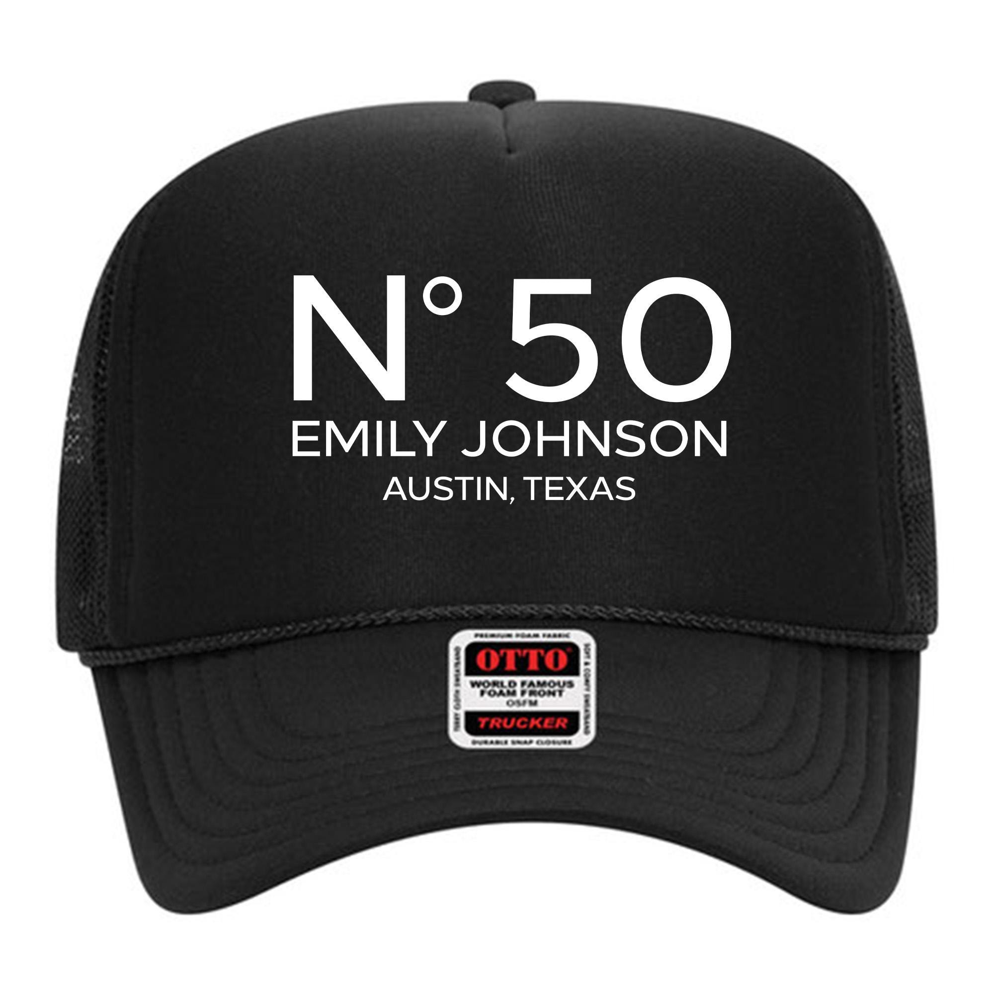 A black baseball cap with white text and a small white sticker on the front.