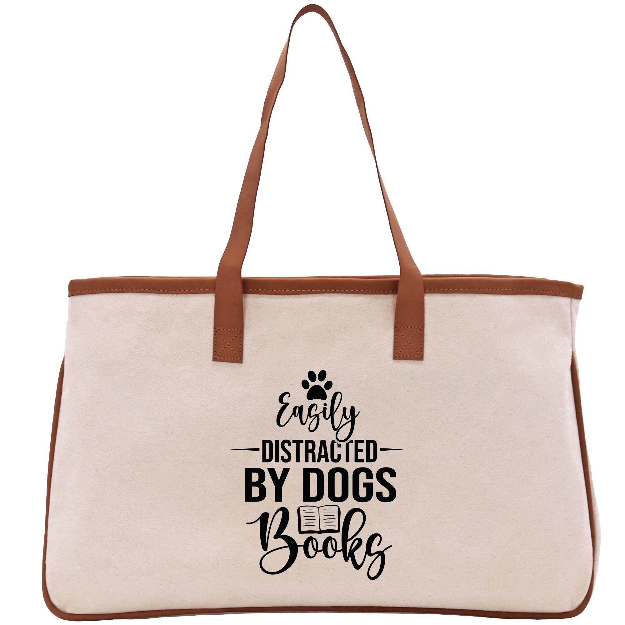a white canvas bag with a brown leather handle
