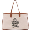 a white canvas bag with a brown leather handle