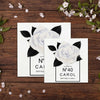 two cards with white flowers and black leaves