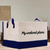 a white and blue shopping bag sitting on top of a wooden table