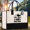 A white tote bag with a black and white graphic of a person fishing and the text 