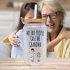 a woman hugging a woman with a glass jar