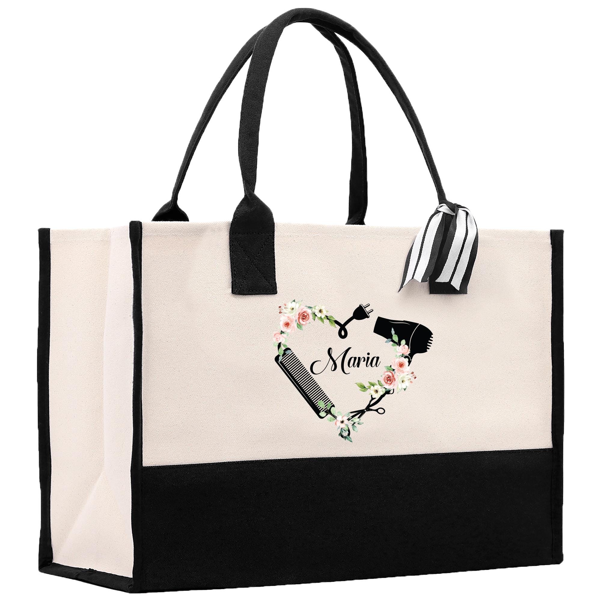 a black and white shopping bag with a black handle