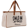 a white canvas bag with a brown leather handle