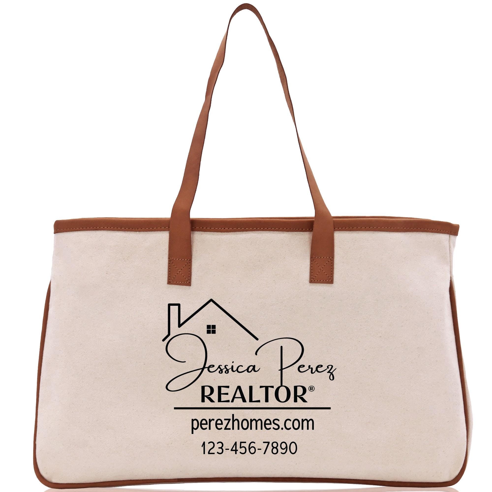 a canvas tote bag with a brown leather handle