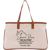 a canvas tote bag with a brown leather handle