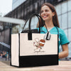 a woman holding a black and white shopping bag