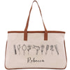 A beige canvas tote bag with a brown leather strap and the name "Recca" printed on it.