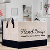 a white and black shopping bag sitting on top of a wooden table