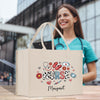 a woman holding a shopping bag that says nurse