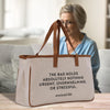 a woman sitting at a table with a bag