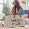 A beige tote bag with the text "Grandma's Sewing Box" printed on it, featuring a sewing kit illustration.