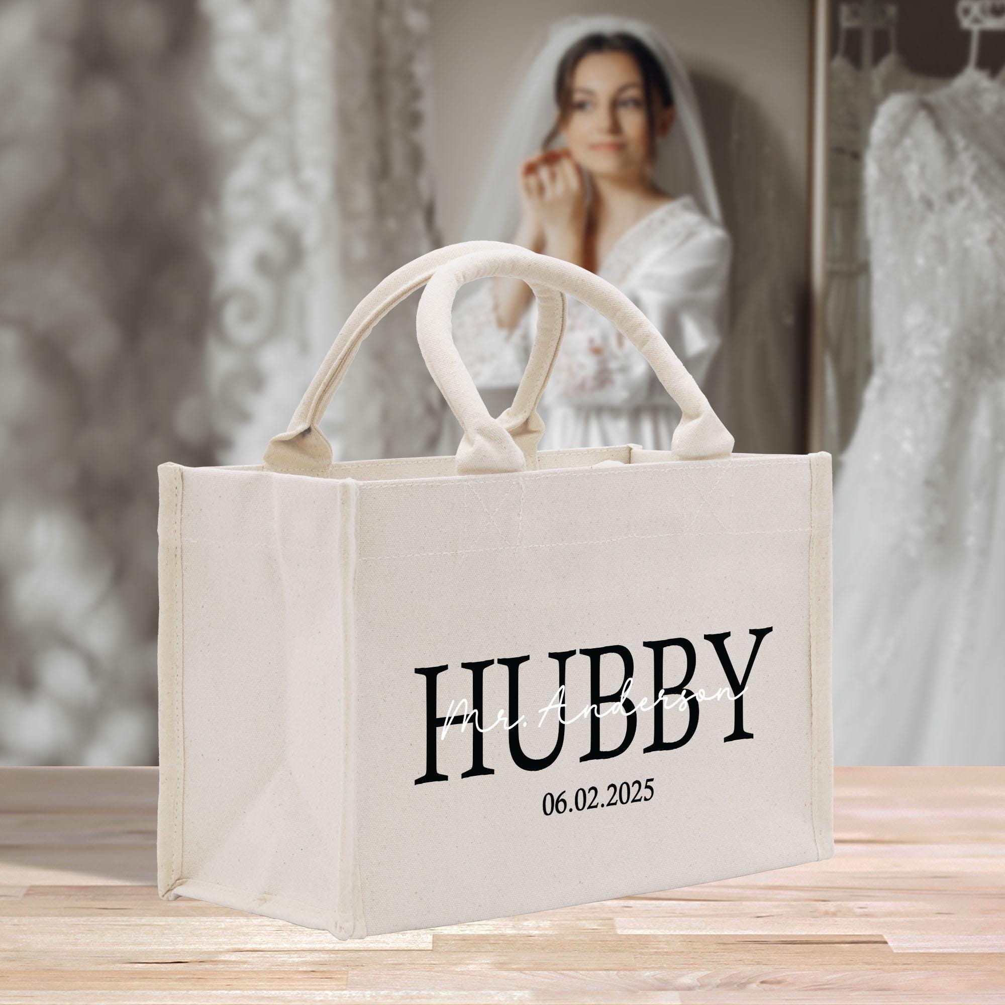 a white shopping bag with the word hubby printed on it
