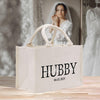 a white shopping bag with the word hubby printed on it