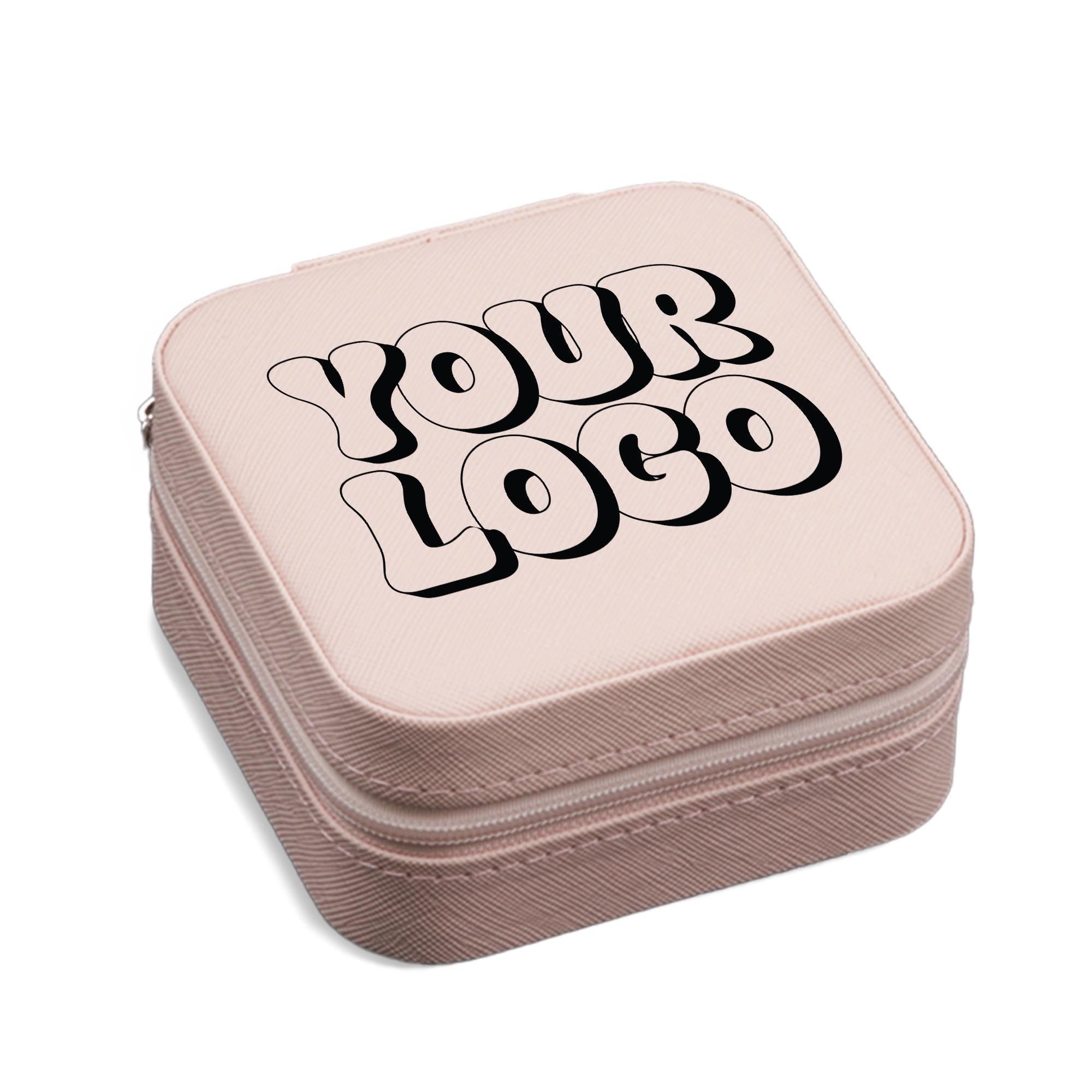 A pink, square-shaped makeup case with the text &quot;YOUR LOGO&quot; printed on it in a stylized font.