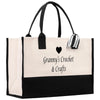 A large tote bag with a black and white color scheme, featuring the text "Granny's Crochet & Crafts" printed on it.