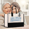an older woman and young girl sitting in front of a bag