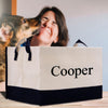 a woman kissing a dog in front of a shopping bag