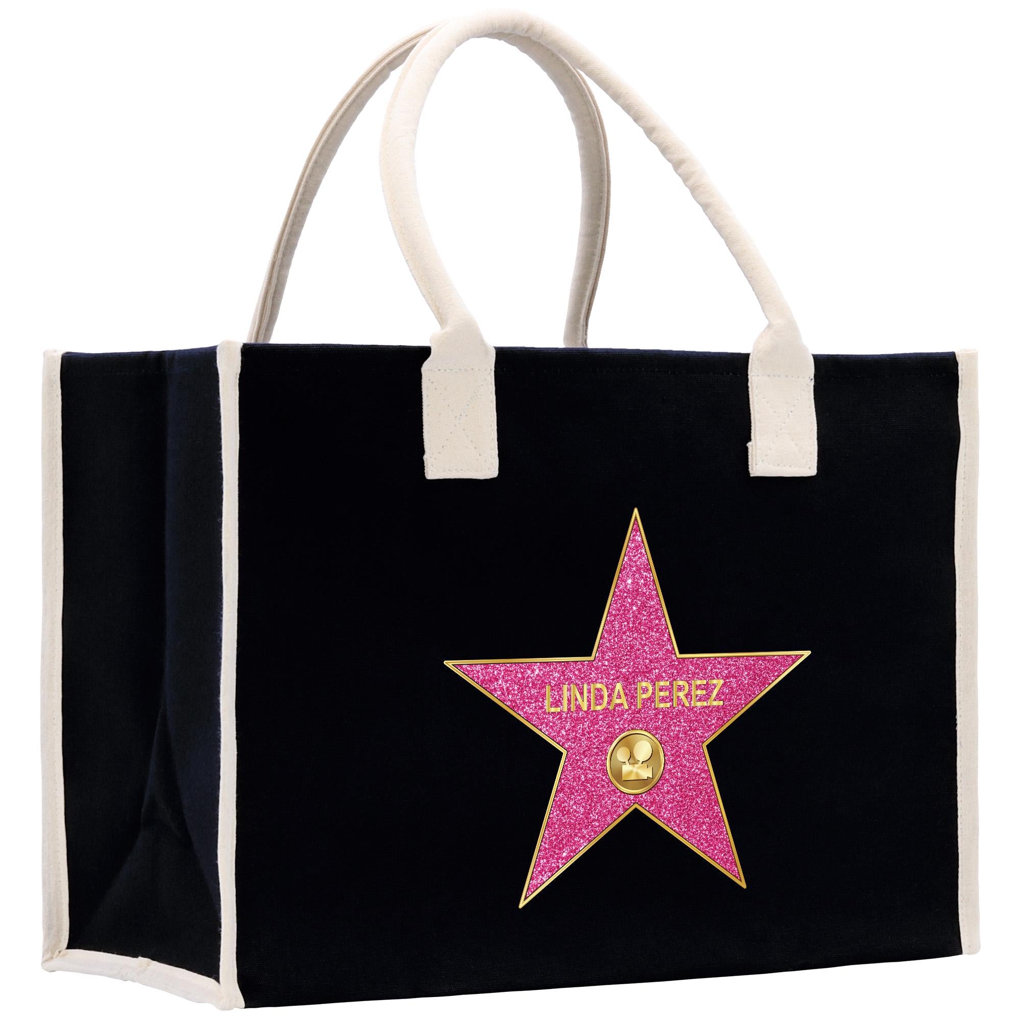 A black tote bag with a pink star-shaped logo on it.