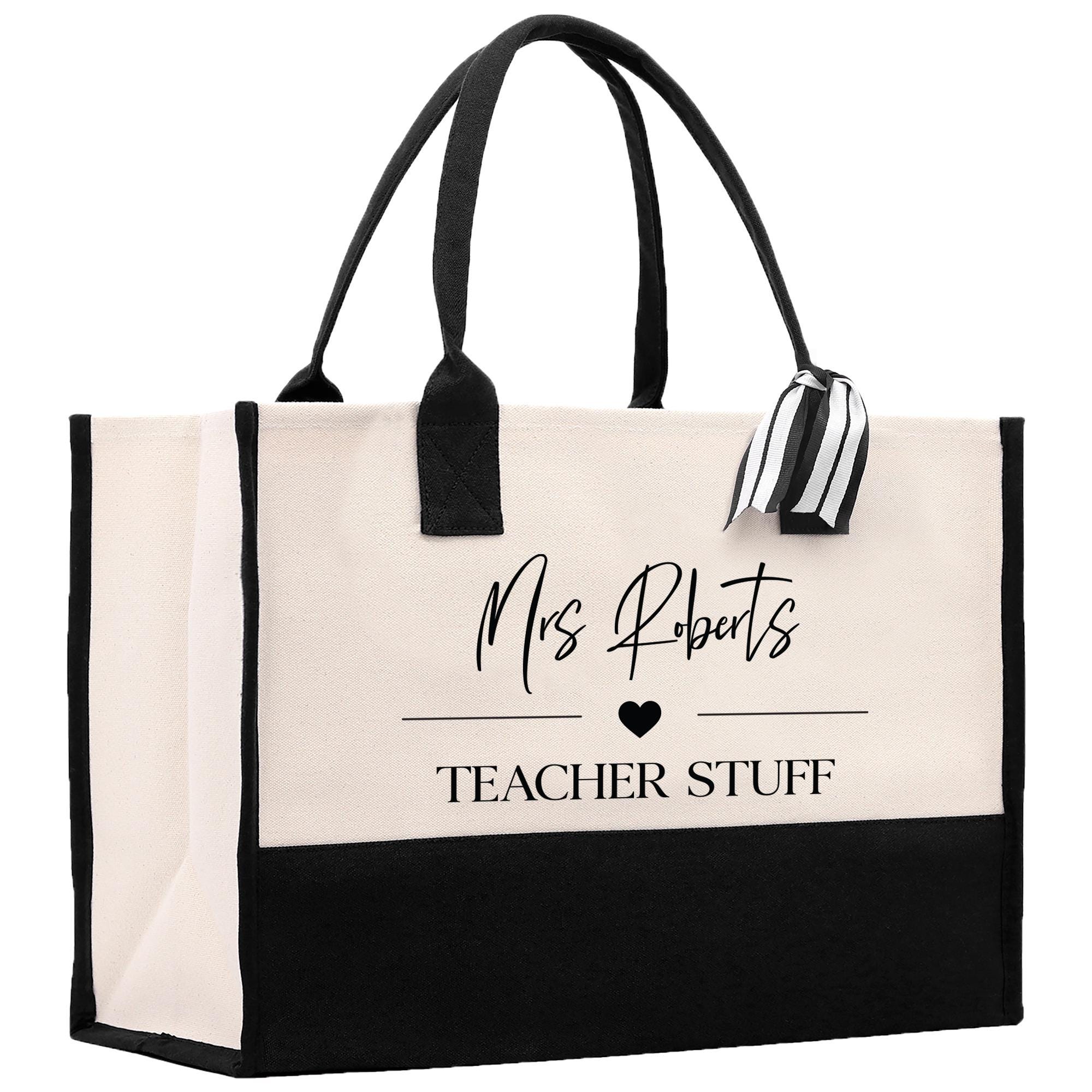 a black and white tote bag with a teacher stuff tag