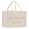 a white shopping bag with embroidered words on it