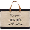 a black and white bag with a leather handle