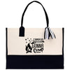 A beige tote bag with a black handle and strap, featuring a printed design that says 