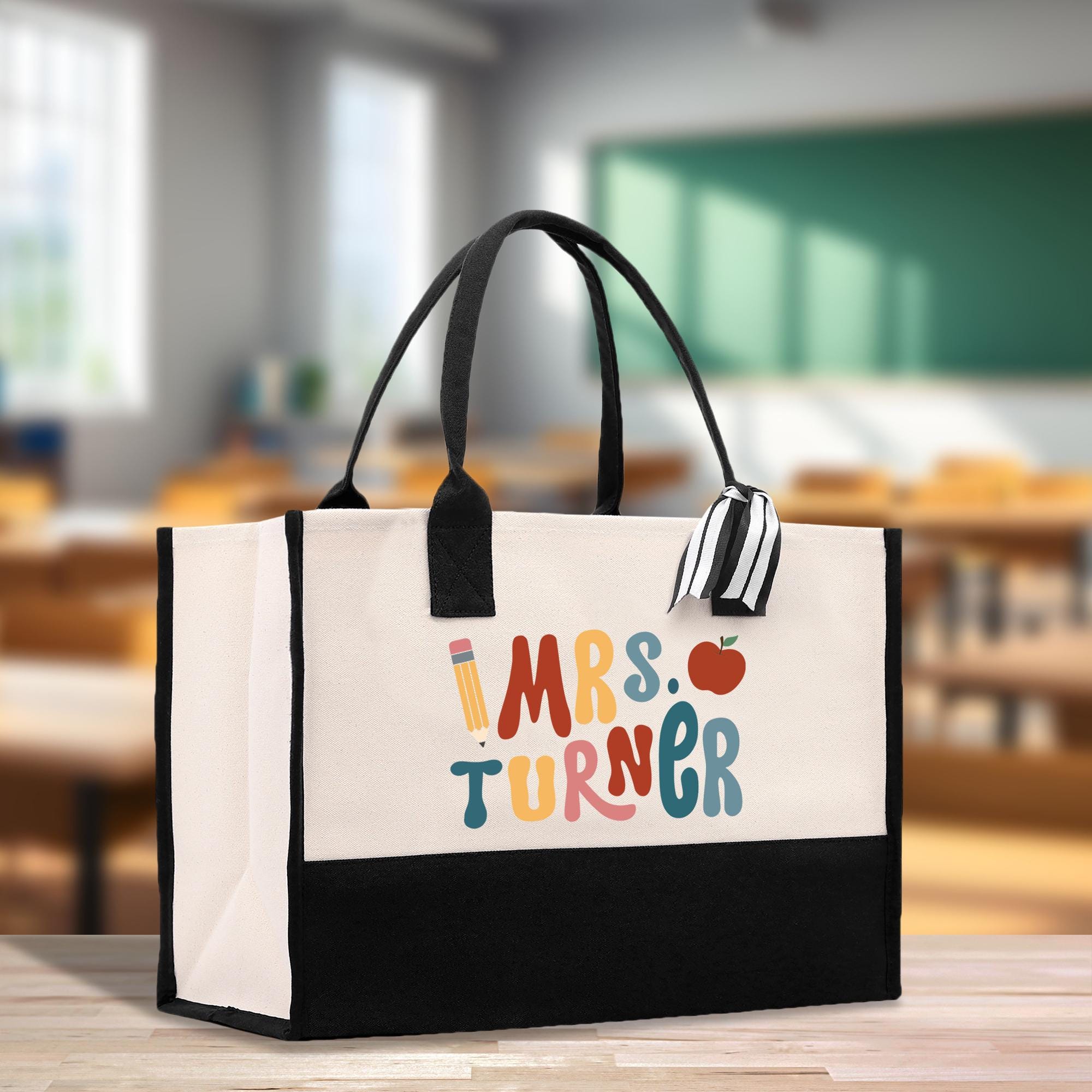 a black and white tote bag sitting on top of a table