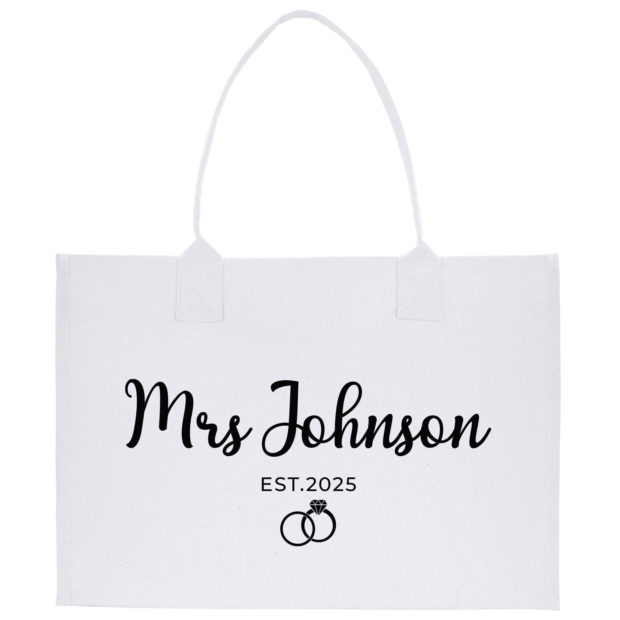 a white bag with a wedding ring on it