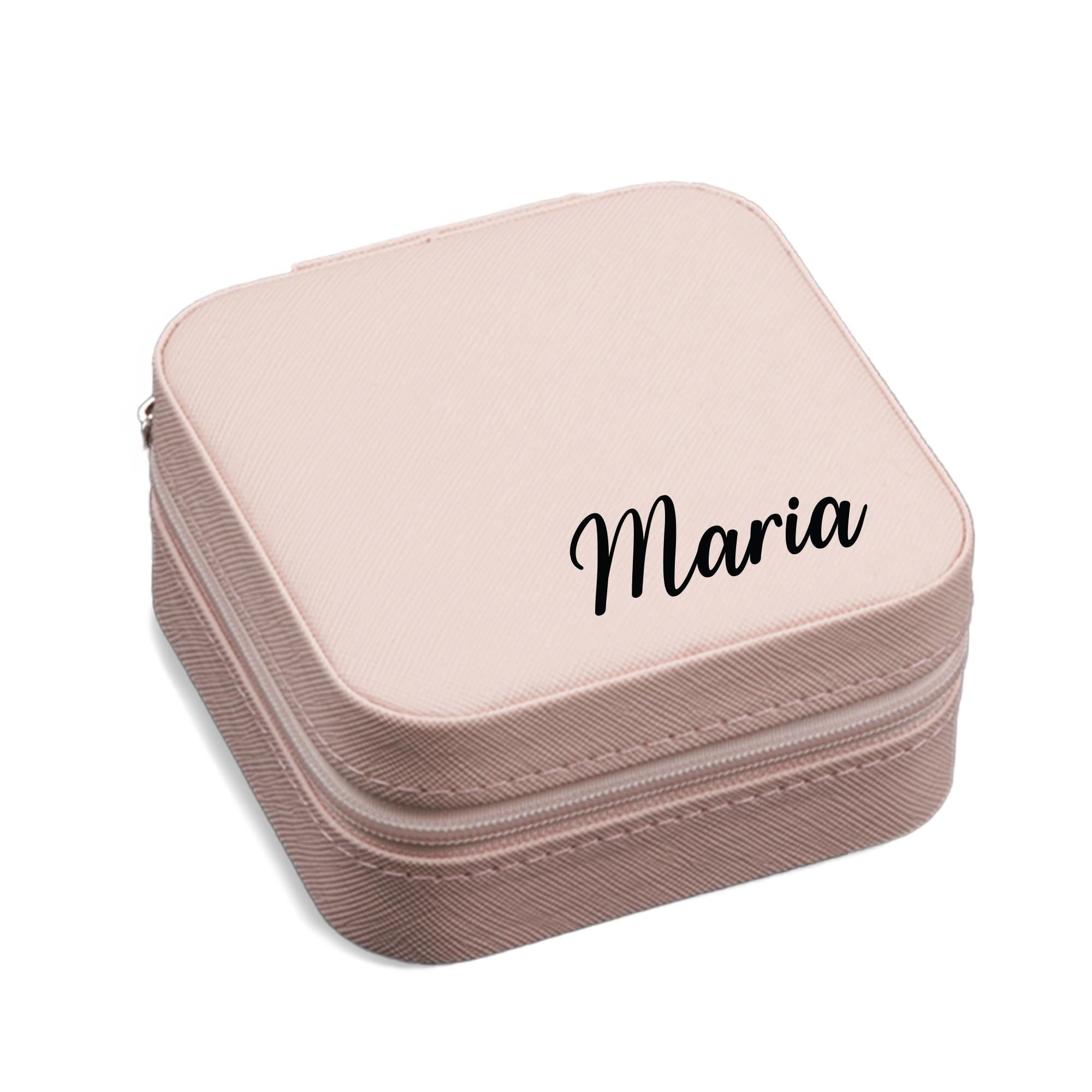 A pink, square-shaped makeup case with the name &quot;Maria&quot; printed on it.