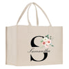 a white bag with a flower and the letter s on it