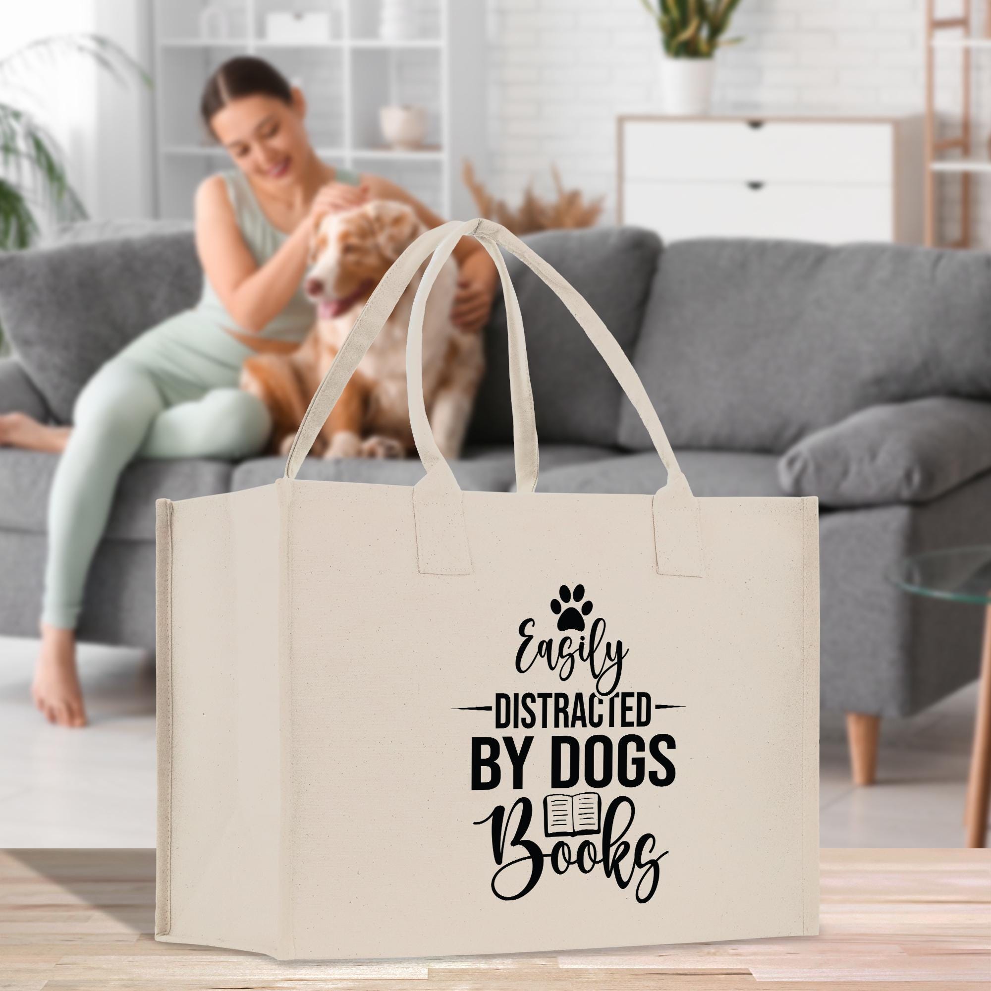 a woman sitting on a couch with a dog in a bag