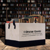 A white tote bag with black text on it, placed on a wooden surface in front of a bookshelf filled with books.