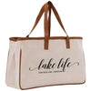 a white bag with a brown leather handle