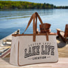 a lake life tote bag sitting on a dock