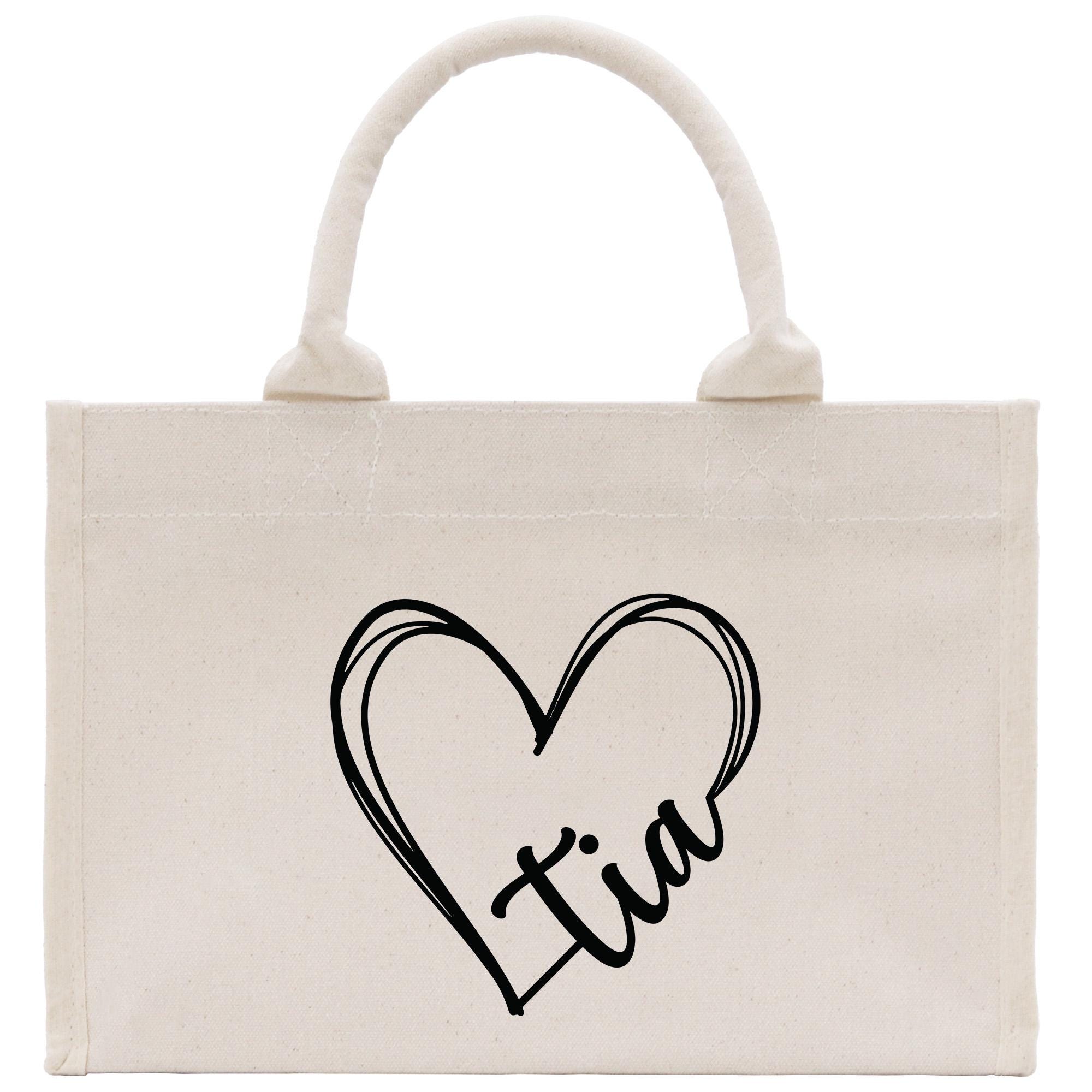 a canvas bag with a heart and initials