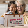 an older woman and a young girl sitting at a table with a bag
