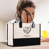a woman sitting at a table with a black and white bag