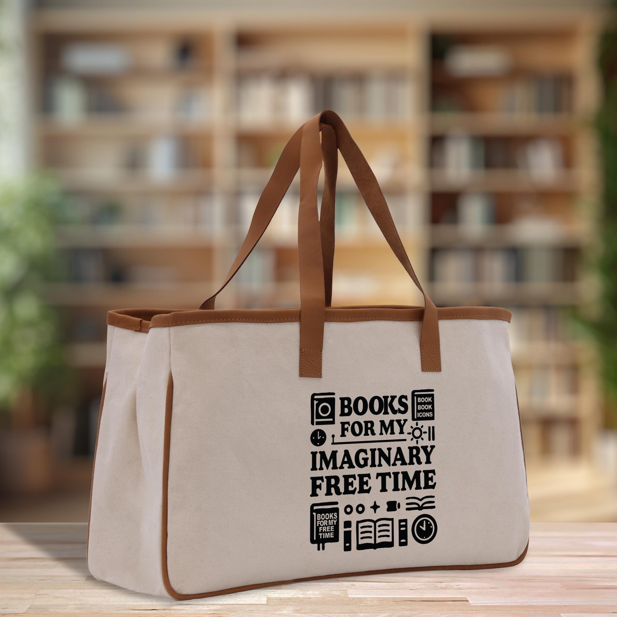 A beige canvas tote bag with the text &quot;BOOKS FOR MY IMAGINARY FREE TIME&quot; printed on it, standing on a wooden surface.