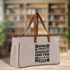 A beige canvas tote bag with the text "BOOKS FOR MY IMAGINARY FREE TIME" printed on it, standing on a wooden surface.