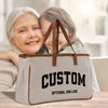 a woman holding a bag with a picture of an older woman on it