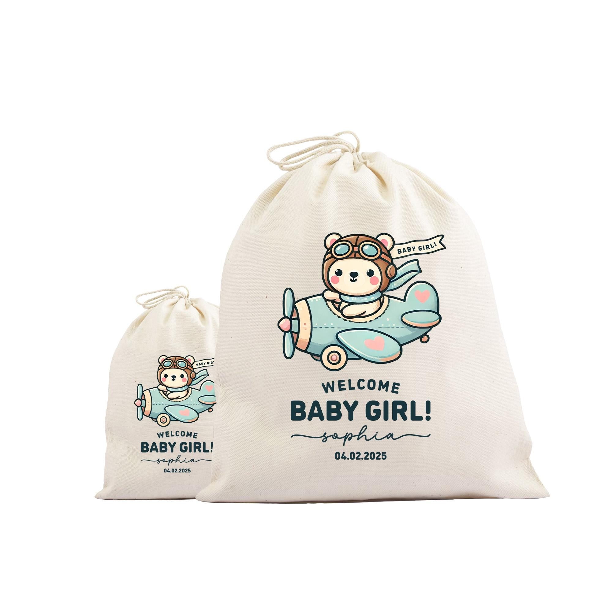 two white drawstring bags with a cartoon image of a baby girl and the text &quot;Welcome Baby Girl! Sophia 04.02.2025&quot; printed on them.