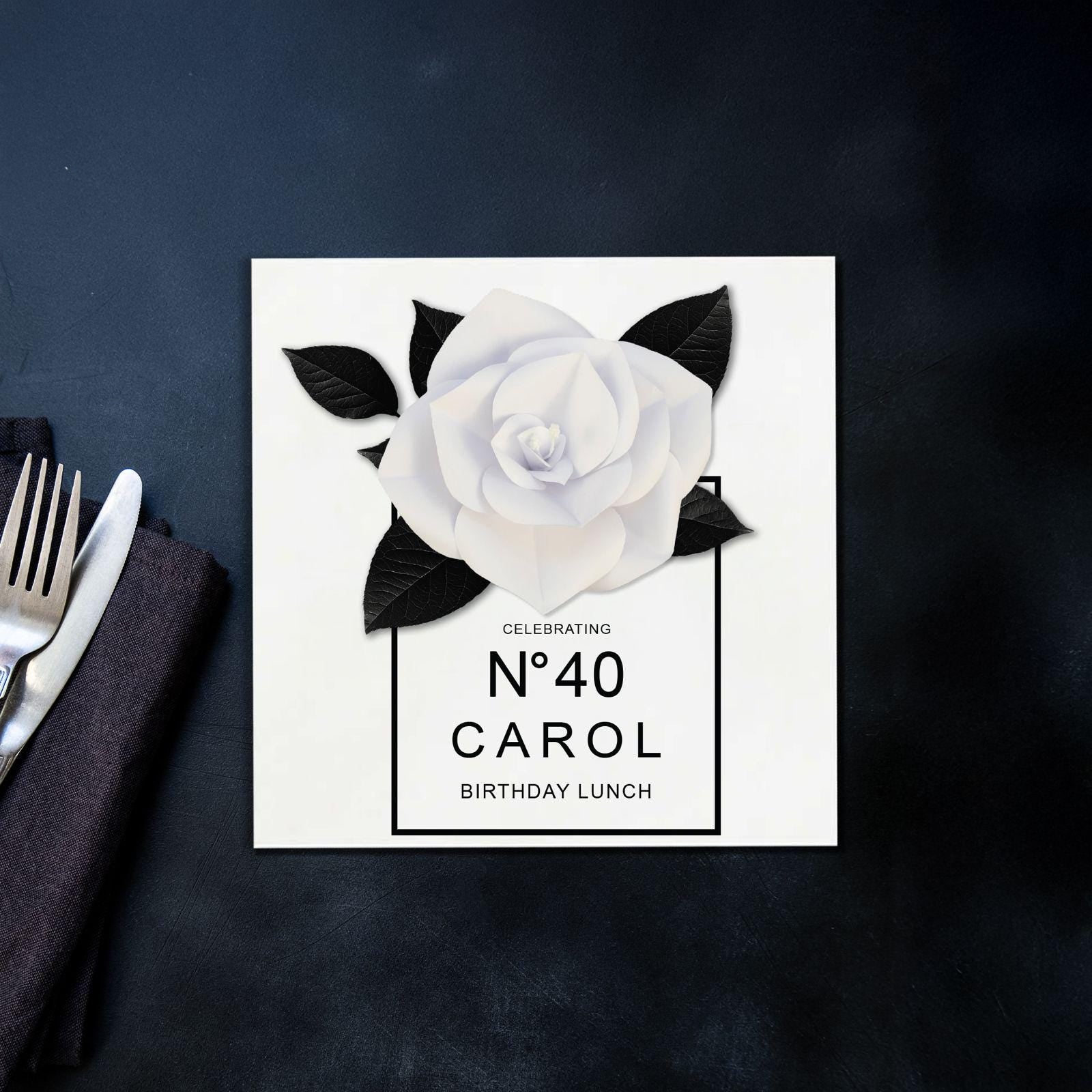 a card with a white rose on it
