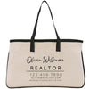 A beige tote bag with black straps and text printed on it.