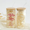 Two glass jars with straws, each containing a white substance, possibly rice or flour. The jars have text printed on them, likely indicating a celebration or special occasion.
