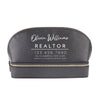 A black leather cosmetic bag with the text "Olivia Williams REALTOR 123.456.7890 www.olivierrealtor.com" printed on it.