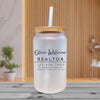a white mason jar with a straw on a wooden table
