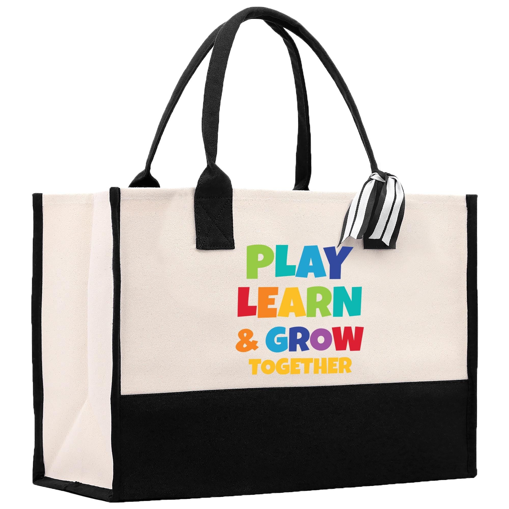 a black and white bag with play learn and grow on it